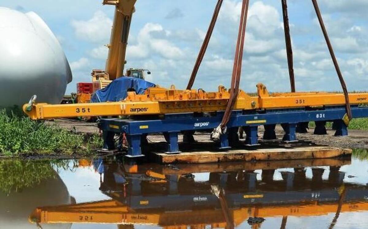 Adam Burden guides a flip plate to a holding position after it is delivered to the Amazon Wind Farm near Elizabeth City in August.