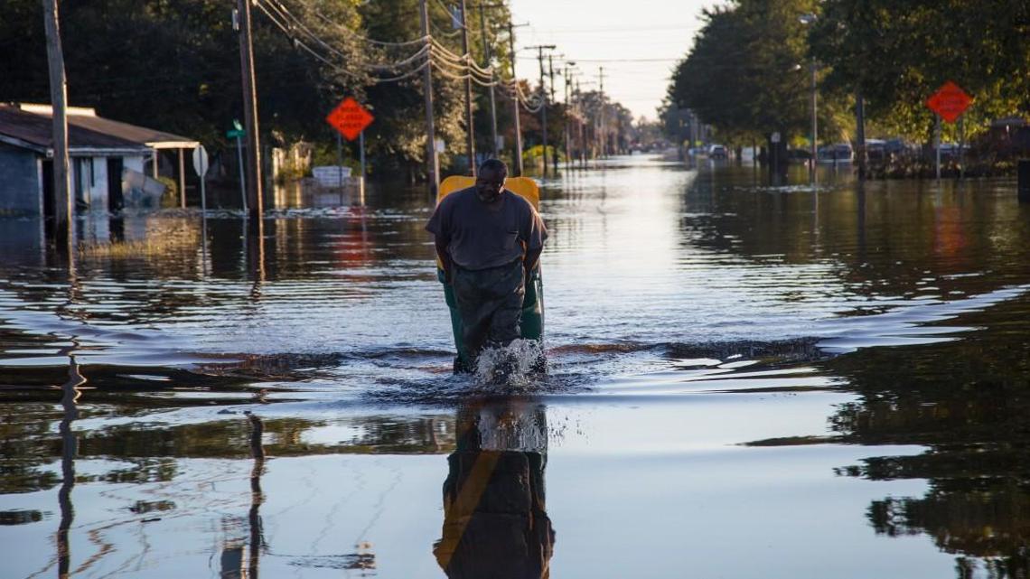 Lumberton resident Michael Anthony pulls a waste bin full of valuables that he retrieved from his flooded home Thursday, October 13, 2016 in Lumberton, NC after Hurricane Matthew caused downed trees, power outages, a municipal water outage and widespread flooding along the Lumber River.
