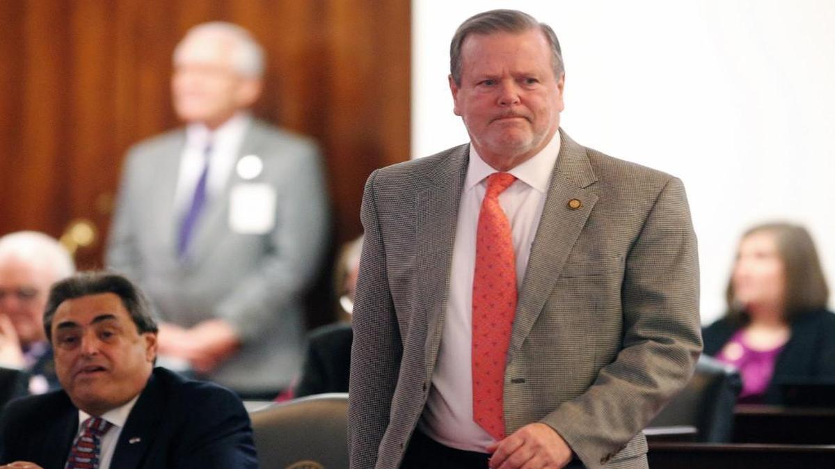 Senate leader Phil Berger (Rep) right, walks across the floor of the chamber as the N.C. General Assembly reconvenes for a special session on Dec. 13, 2016.