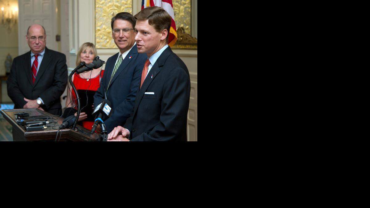 
Incoming State Budget Director Lee Roberts, right, speaks after he was introduced by Gov. Pat McCrory, second from right, during a press conference at the Governor's Mansion in Raleigh on Aug. 6, 2014. Outgoing Budget Director Art Pope, left, and his wife, Kathy Pope, listen at left. A new state law has ended the decades-old practice of automatically building in numbers that account for expected growth, such as covering the cost of more children attending public schools each year. Budget writers said they like the change in how the budget is built because it will lead to what they said is more accurate reporting later on of spending decisions. 


