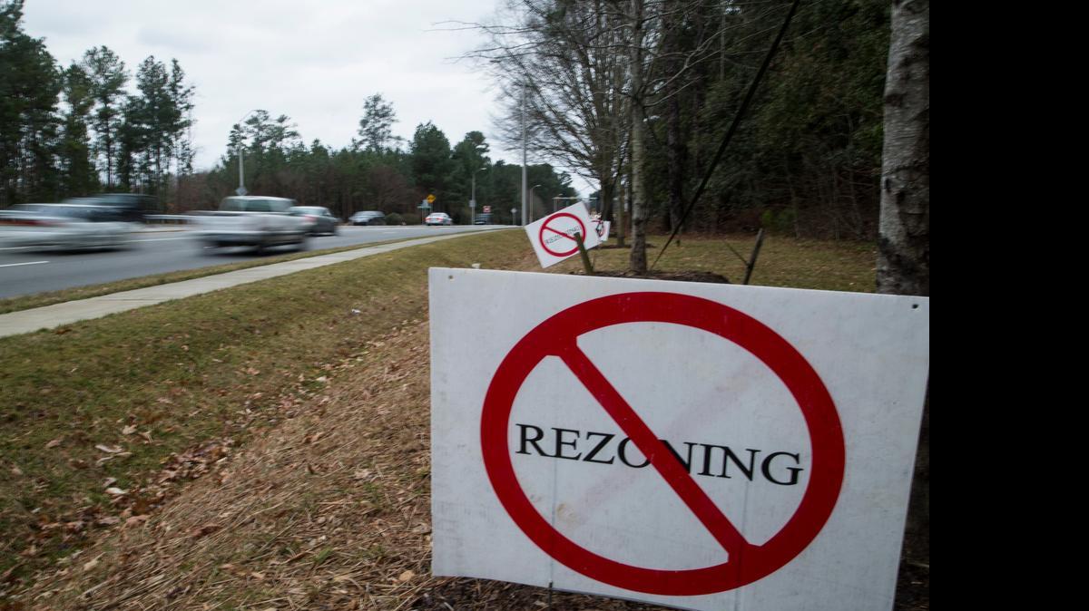 
Signs opposing a zoning change to allow a Publix grocery store in North Raleigh line Falls of Neuse Road in January. The procedure neighbors used to stop the store, known as a protest petition, would be eliminated under HB 201.

