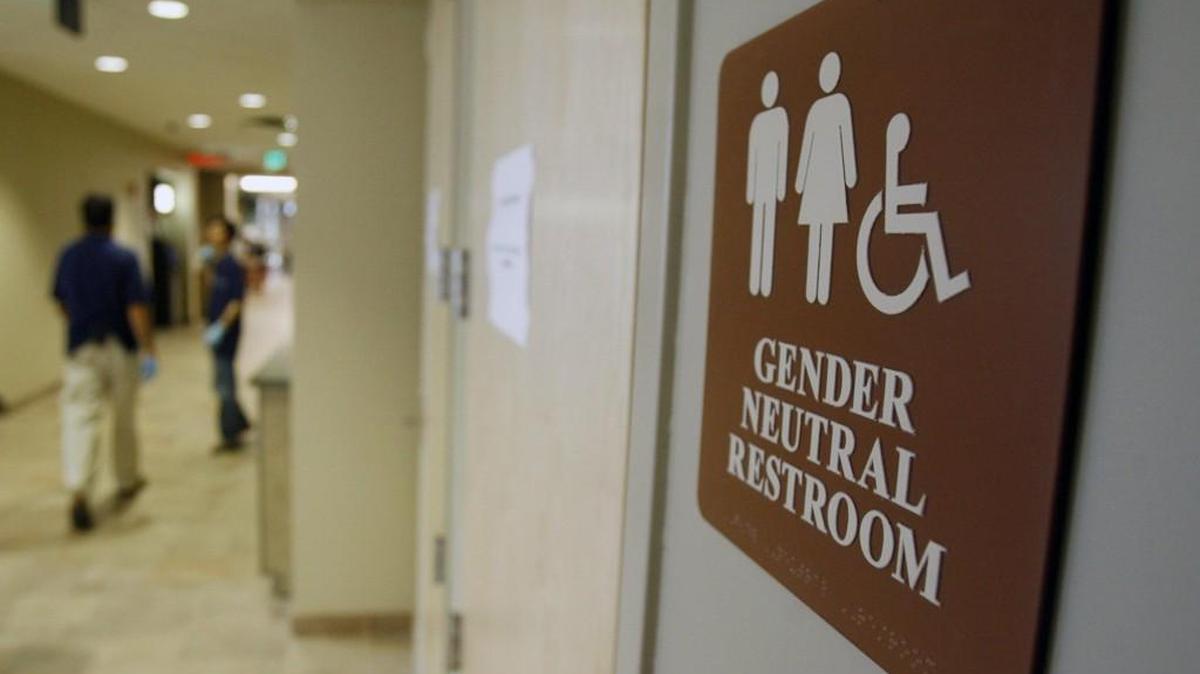 FILE- In this Aug. 23, 2007, file photo, a sign marks the entrance to a gender-neutral restroom at the University of Vermont in Burlington, Vt. The legal clash over transgender rights pitting North Carolina against the Justice Department boils down to a fundamental disagreement over a definition.