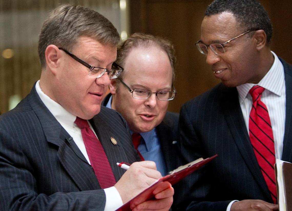 From left, Speaker of the House Tim Moore, Commissioner of Insurance Wayne Goodwin, and Kevin Howell, assistant to the chancellor at N.C. State University, huddle before registering in a bone marrow drive Wednesday, August 5, 2015 in the 1300 courtyard at the N.C. General Assembly building in Raleigh.