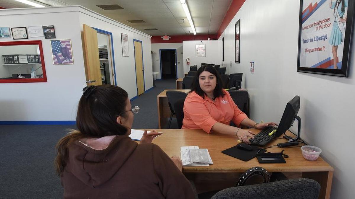
Juanita Ahl (right), office manager at the Liberty Tax Service in Selma, helps customer Kathleen Johnson start the process of filing her taxes Friday, March 6, 2015. Changes in the North Carolina state income taxes found some people paying money back to the state while others received a refund. 
