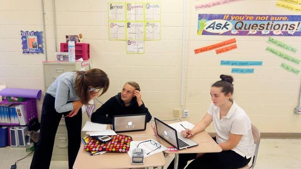 Jaclyn Nelson talks with her students Kelsi Gibson, left, and Katherine Herring during Math I class at Jones Senior High School in Trenton, N.C. Thursday, Oct. 22, 2015.