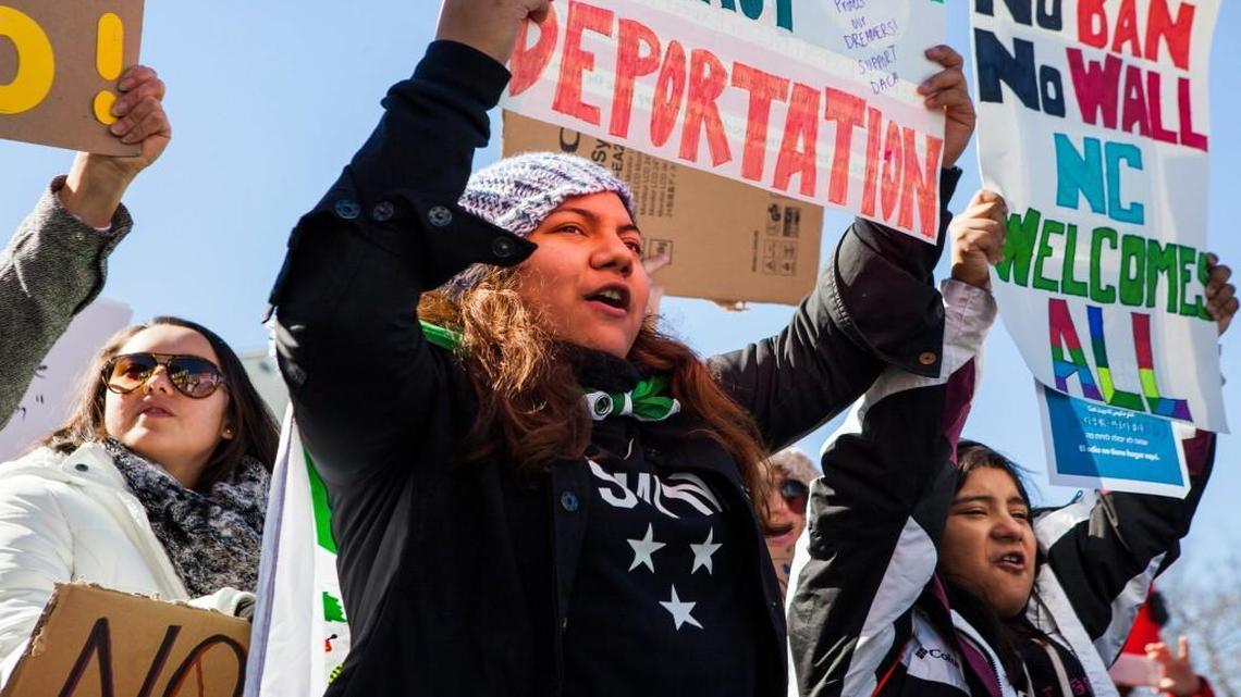 A current DACA student, Linda David, center and her sister Natalie David, right, voice their opposition to the immigration and refugee policies of President Donald Trump during a rally on Halifax Mall on Saturday Feb. 4, 2017, in Raleigh, NC.