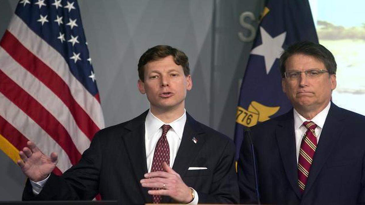 
State Budget Director Lee Roberts, left, addresses members of the media, as N.C. Governor Pat McCrory listens in the Joint Force Headquarters Media Briefing Room in Raleigh, N.C. on Thursday, March 5, 2015. They unveiled the governor's proposed 2015-2017 budget for the state.
