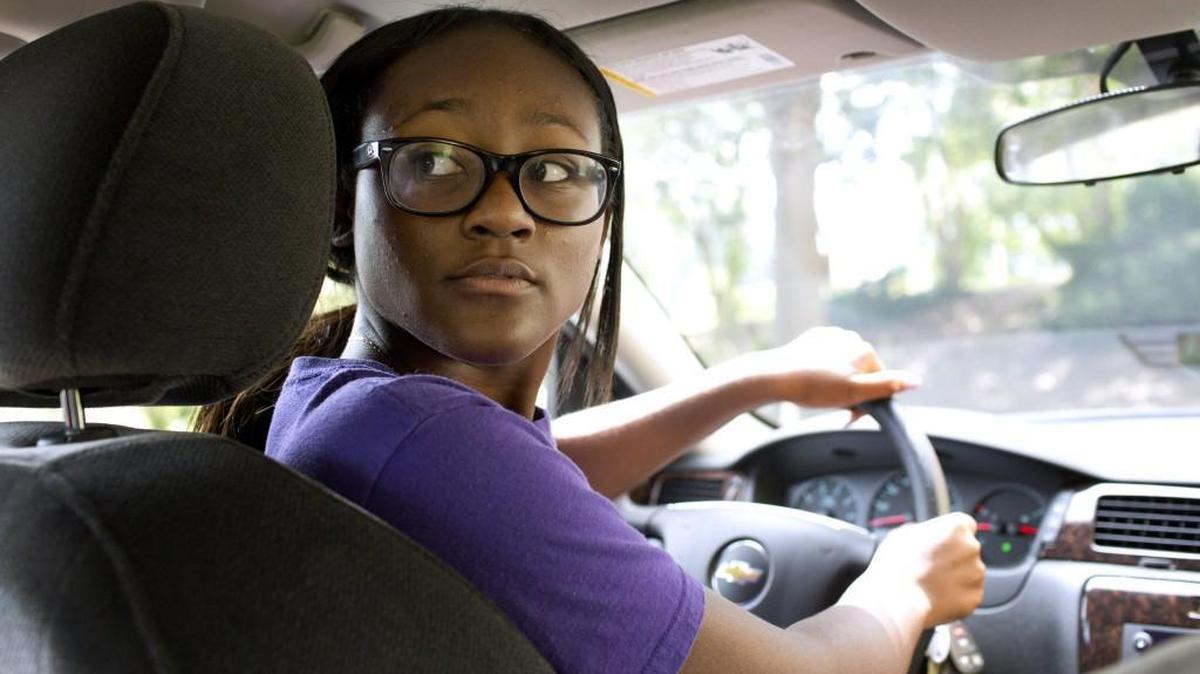 
Sherese Lingard, 16, looks behind the car before reversing during the the behind-the-wheel portion of driver's education program run by Jordan Driving School Wednesday, August 19, 2015 in Raleigh, N.C.
