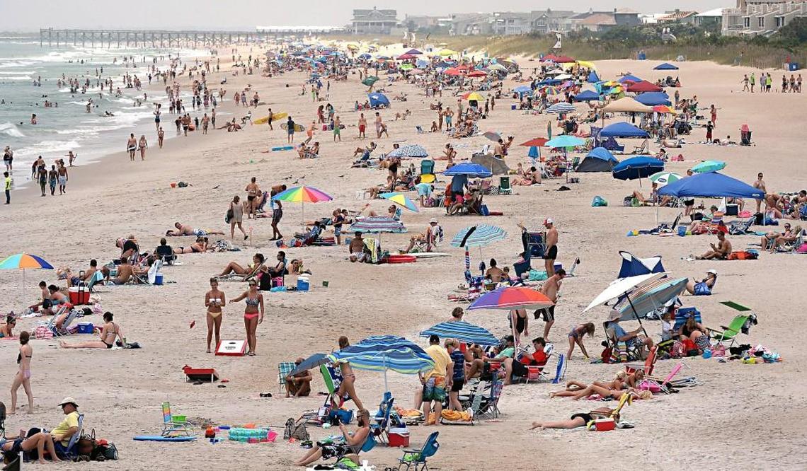 The beach stand looking south from the Johnny Mercer pier at Wrightsville Beach, NC, on July 2, 2015, is crowded with thousands of vacationers. The school calendar law was passed with the support of the tourism industry, which was worried about how schools were shortening summer break.