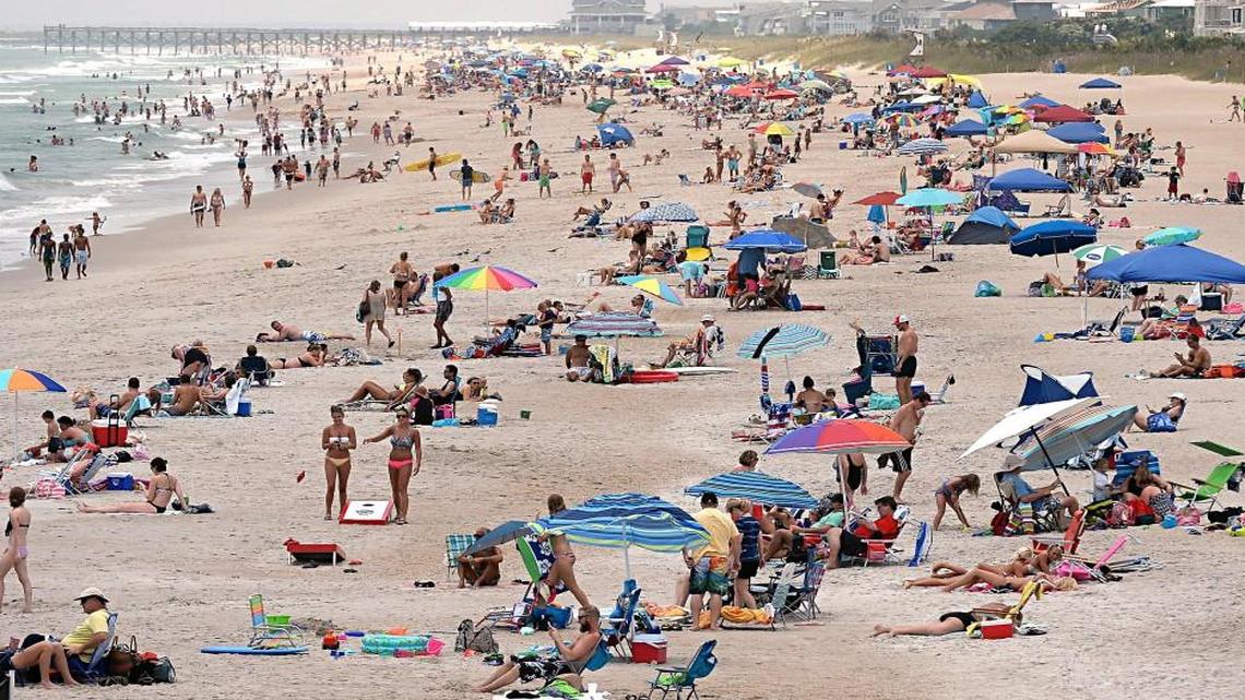 The beach stand looking south from the Johnny Mercer pier at Wrightsville Beach, NC, on July 2, 2015, is crowded with thousands of vacationers. The school calendar law was passed with the support of the tourism industry, which was worried about how schools were shortening summer break.
