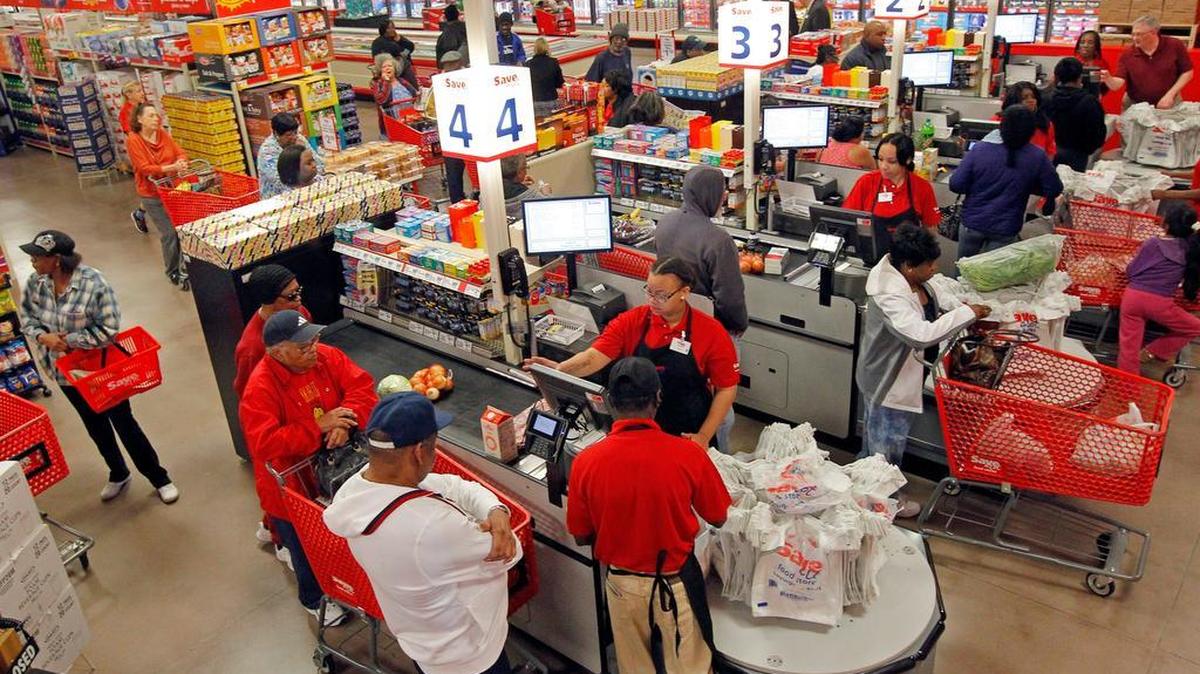 
Cashiers ring up sales at the Save-A-Lot grocery store in Raleigh. A proposed shift in sales tax revenues would mean Wake County would get less sales tax revenue than it receives under current law.
