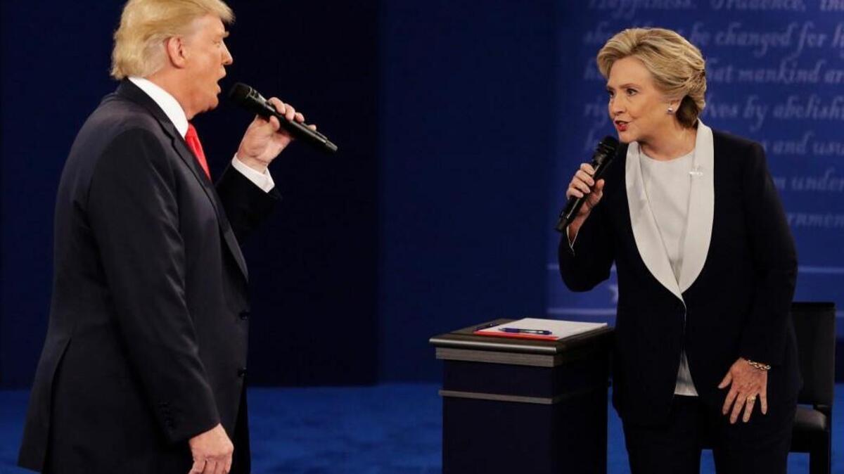 In this Sunday, Oct. 9, 2016, file photo, Republican presidential nominee Donald Trump and Democratic presidential nominee Hillary Clinton speak during the second presidential debate at Washington University in St. Louis.