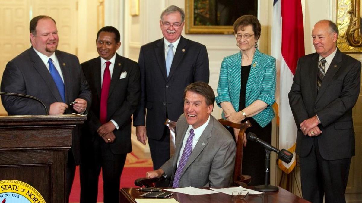 North Carolina Gov. Pat McCrory smiles after recognizing Sen. Ralph Hise, left, during the signing of the Medicaid privatization legislation on Wednesday, September 23, 2015 at the Executive Mansion in Raleigh, N.C.