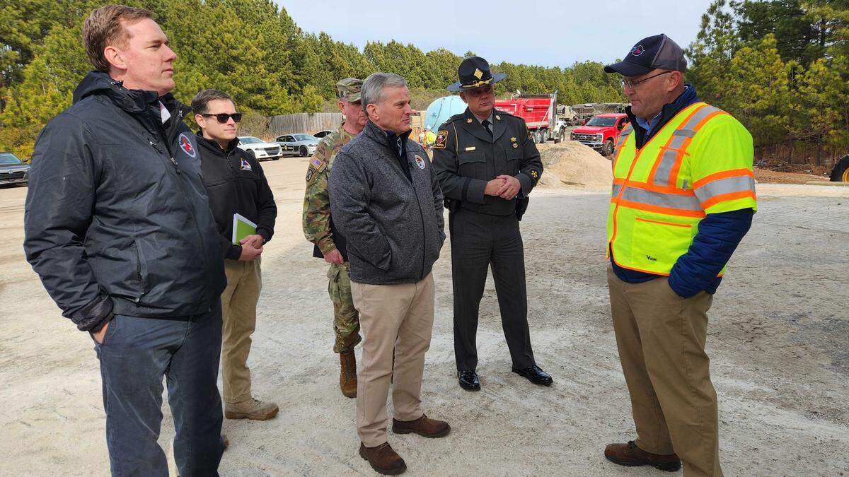 North Carolina Gov. Josh Stein and other state officials talk with N.C. Department of Transportation division maintenance engineer Doug McNeal at NCDOT’s brine and rock salt supply area off Westgate Road in Raleigh, N.C., on Thursday, Jan. 29, 2026.