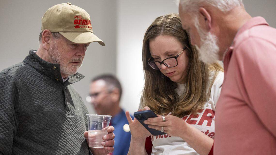 N.C. Sen. Phil Berger, left, an Eden Republican and Senate leader, checks election results with his daughter and supporter, Ashley Snyder, after Berger made a statement that the race was too close to call during a primary election night watch party in Reidsville on Tuesday, March 3, 2026. Berger is running against Rockingham County Sheriff Sam Page. The district also includes part of Guilford County.