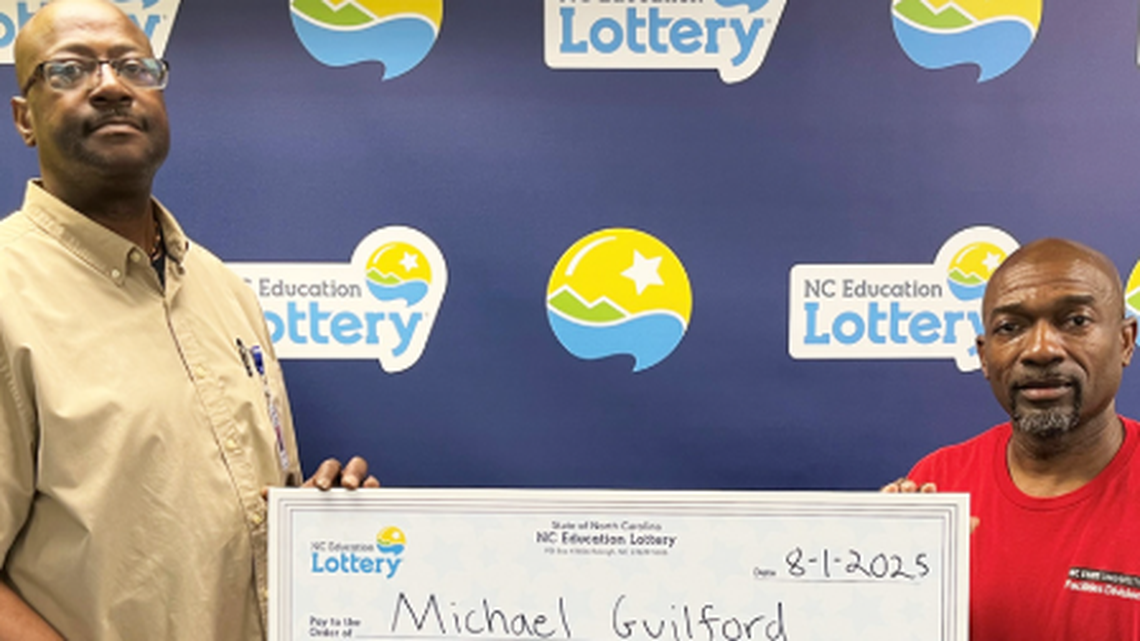 Michael Guilford, left, is pictured with his husband Basil Battle after he won a $250,000 lottery prize.
