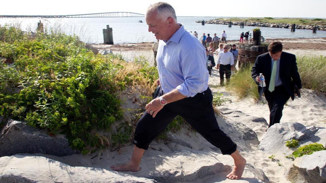 
North Carolina Secretary of the Department of Transportation Tony Tata climbs the sand dunes in the bare feet following a press conference at the base of the Bonner Bridge on Monday June 15, 2015 in the Cape Hatteras National Seashore on the North Carolina Outer Banks. Lawyers for two conversation groups have agreed to drop their lawsuits and allow the North Carolina Department of Transportation to build a new bridge to replace the aging Bonner Bridge.
