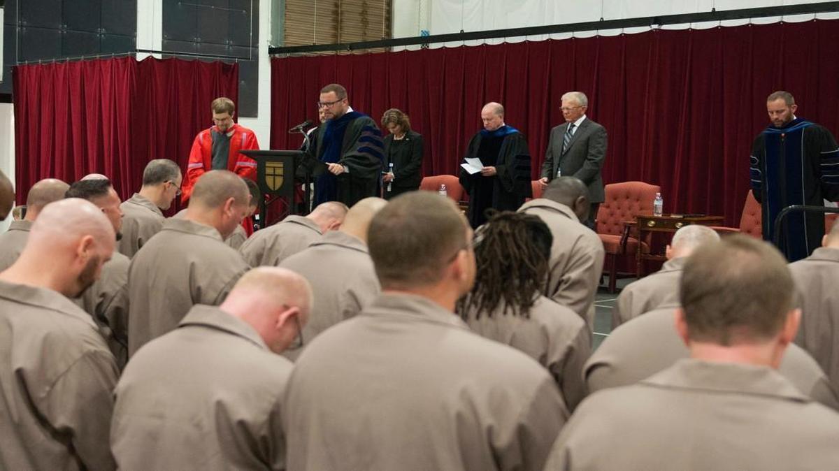In this 2017 photo, Dr. Jamie Dew, the dean of The College at Southeastern in Wake Forest, was leading a prayer at Nash Correctional Institution. 