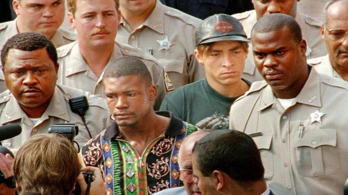 Surrounded by deputies, Daneil Green, foreground, and Larry Demery enter the Robeson County Courthouse in 1993 for arraignment in the slaying of James Jordan.