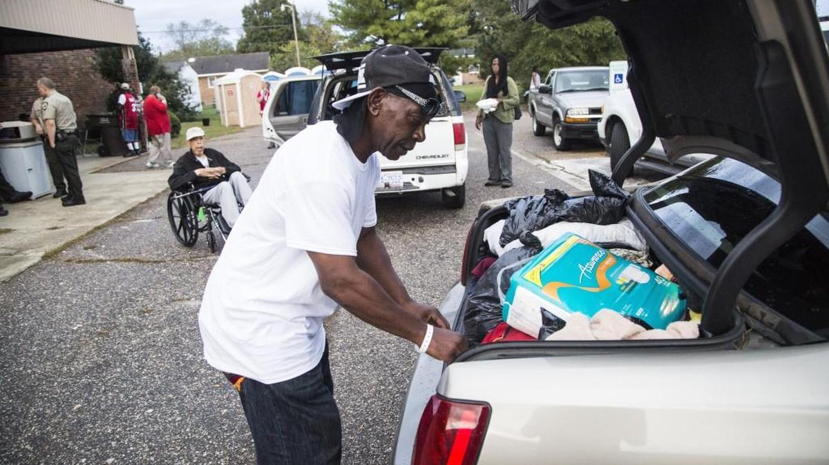 Leroy Sherrod packs his belonging into the trunk of a car after he was told he could return to his home after staying in an emergency Red Cross Shelter for days Friday, October 21, 2016 at the Robert C. Farmer Center in Tarboro which is being used as a Red Cross emergency shelter for displaced residents on nearby Princeville. Some residents are being allowed back into Princeville after millions of gallons of floodwaters were pumped from the flooded town in the Tar River.
