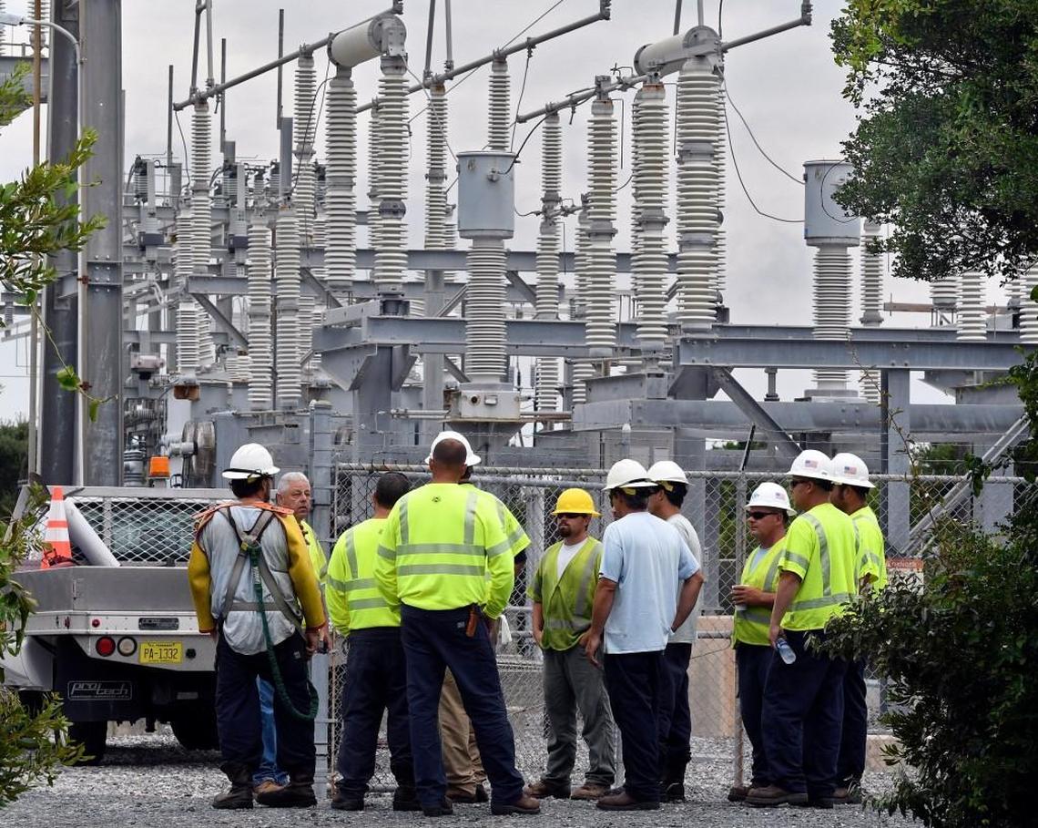 Cape Hatteras Electric Cooperative linemen get orders from a supervisor at a Hatteras Island substation where generators are running after a construction crew cut the power cable that supplies Hatteras Island with electricity.