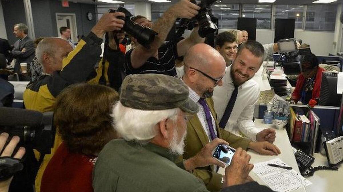2014 FILE PHOTO: A couple receives one of the first marriage licenses issued to a same-sex couple in Mecklenburg County last October. A new lawsuit aims to strike down an. N.C. law that allows officials to stop issuing the licenses or performing same-sex marriages in they violate their spiritual beliefs.
