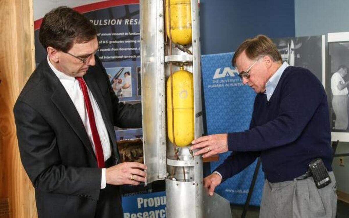 
James Blackmon, principal research engineer for the University of Alabama at Huntsville Propulsion Research Center, right, opens a crate sealed in 1957 that contains a rocket he created as a teen. Robert Frederick, left, director of the Propulsion Research Center was present at the March 19 unveiling.
