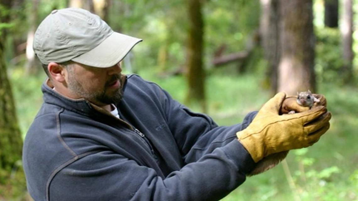 UNC-Wilmington associate professor of biology Brian Arbogast and a Humboldt’s flying squirrel.