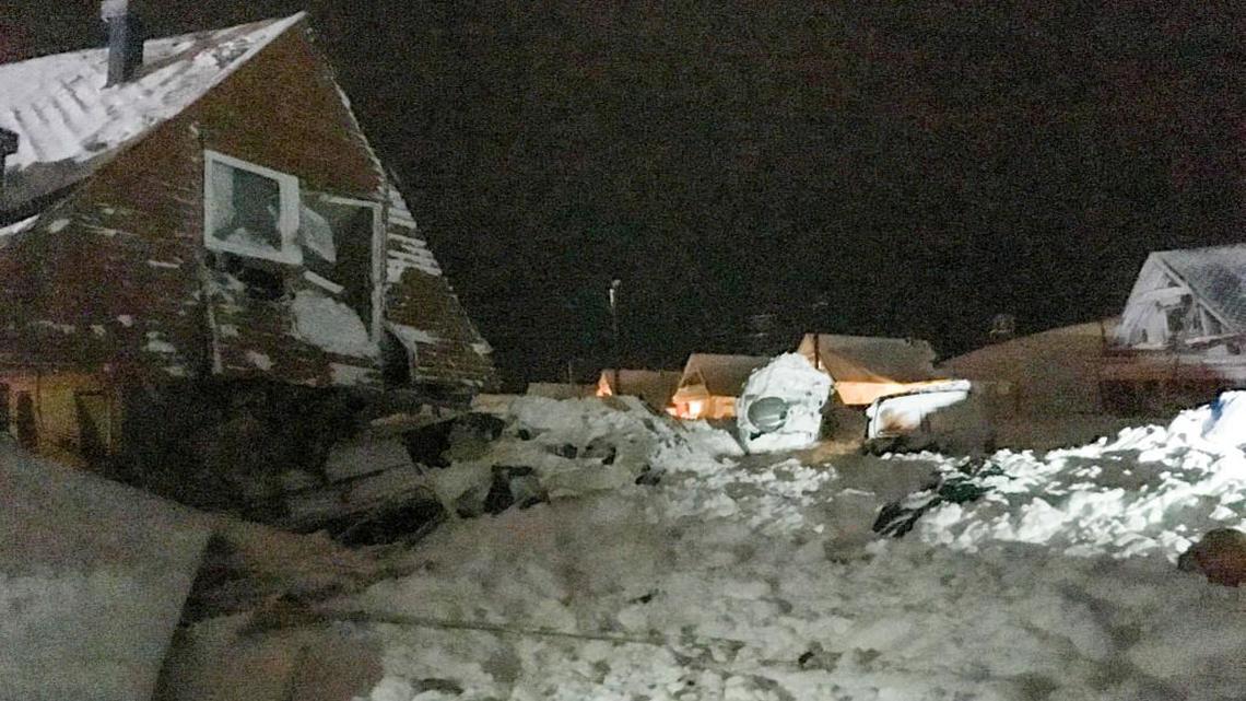 Houses are snow-covered as an avalanche hit Longyearbyen, Norway, in December. A team at Duke University is using little hydrogel beads to learn more about the physics of small particles that collectively can cause avalanches and landslides.