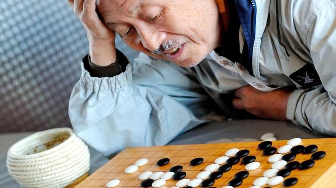 A man plays Go game in the hall of the Grand Palais in Lille, northern France. AlphaGO, the software developed by Google DEEPMIND, defeated a human being in a GO game for the first time.