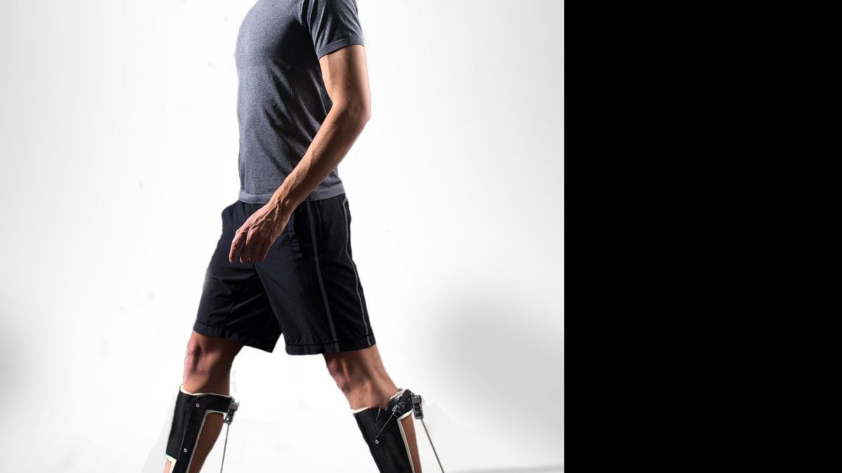 
The add-on exoskeleton in action: The energy required for walking on a treadmill dropped 7 percent when the walker wore it. 
