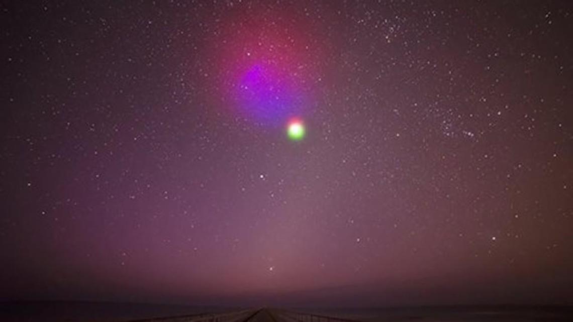 A photograph from a ground camera stationed in Duck, North Carolina designed to view vapor tracers released in the upper atmosphere by a NASA rocket.