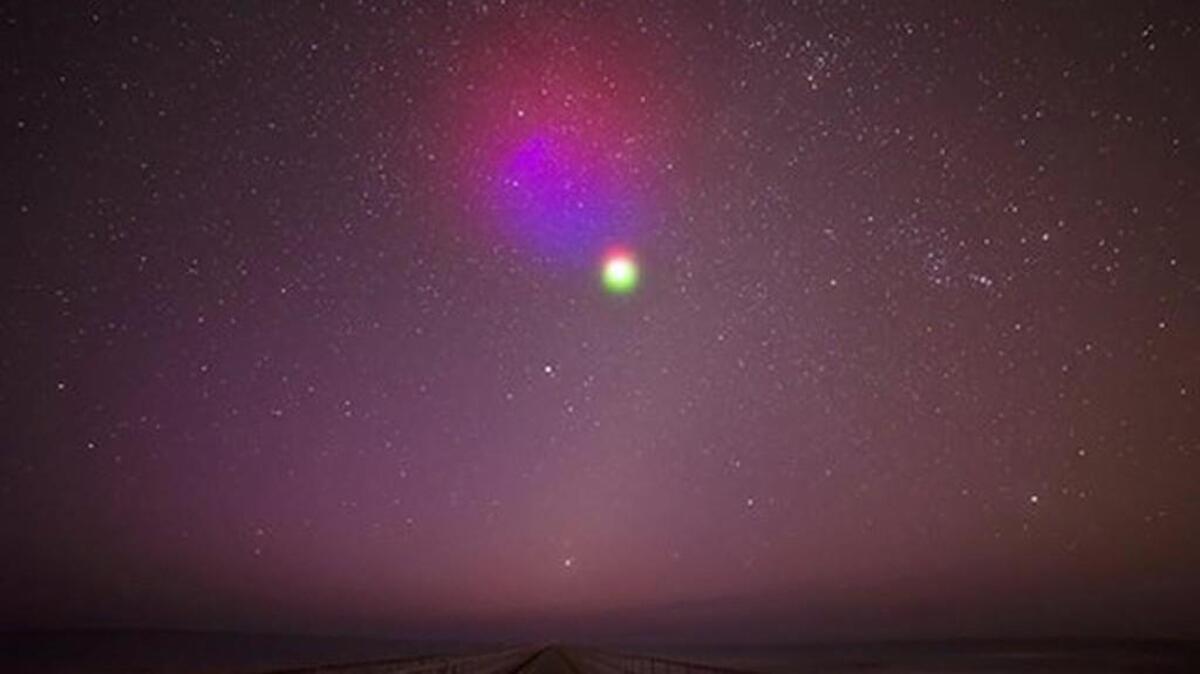 A photograph from a ground camera stationed in Duck, North Carolina designed to view vapor tracers released in the upper atmosphere by a NASA rocket.