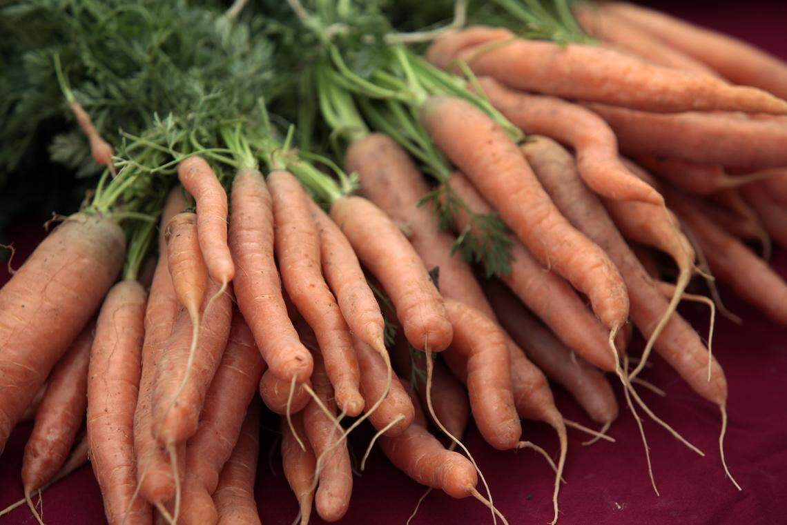 These fresh winter carrots from Vicki Salisbury's S&H Farm in Oxford, NC brighten up the early spring offerings of fresh produce at the opening of the Chapel Hill Farmers' Market on Tuesday, April 22, 2014.