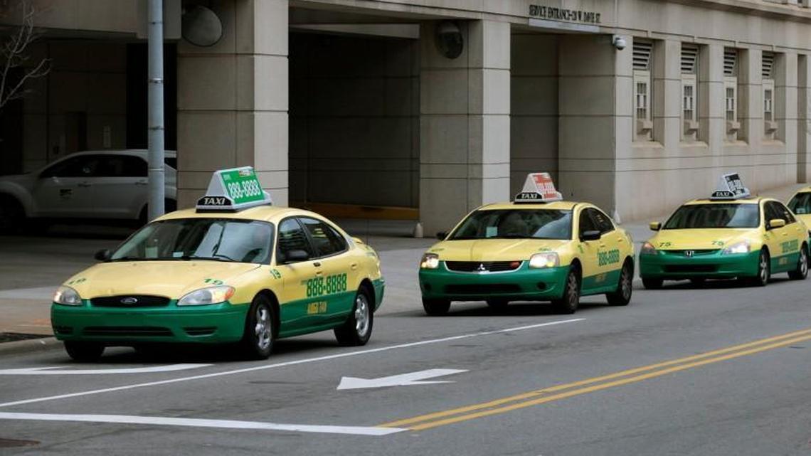 Amigo Taxis circle the Wake County Justice Center in downtown Raleigh in this file photo from February 2016. Cab owners in North Carolina must carry higher liability insurance starting Oct. 1 under a bill passed this summer.