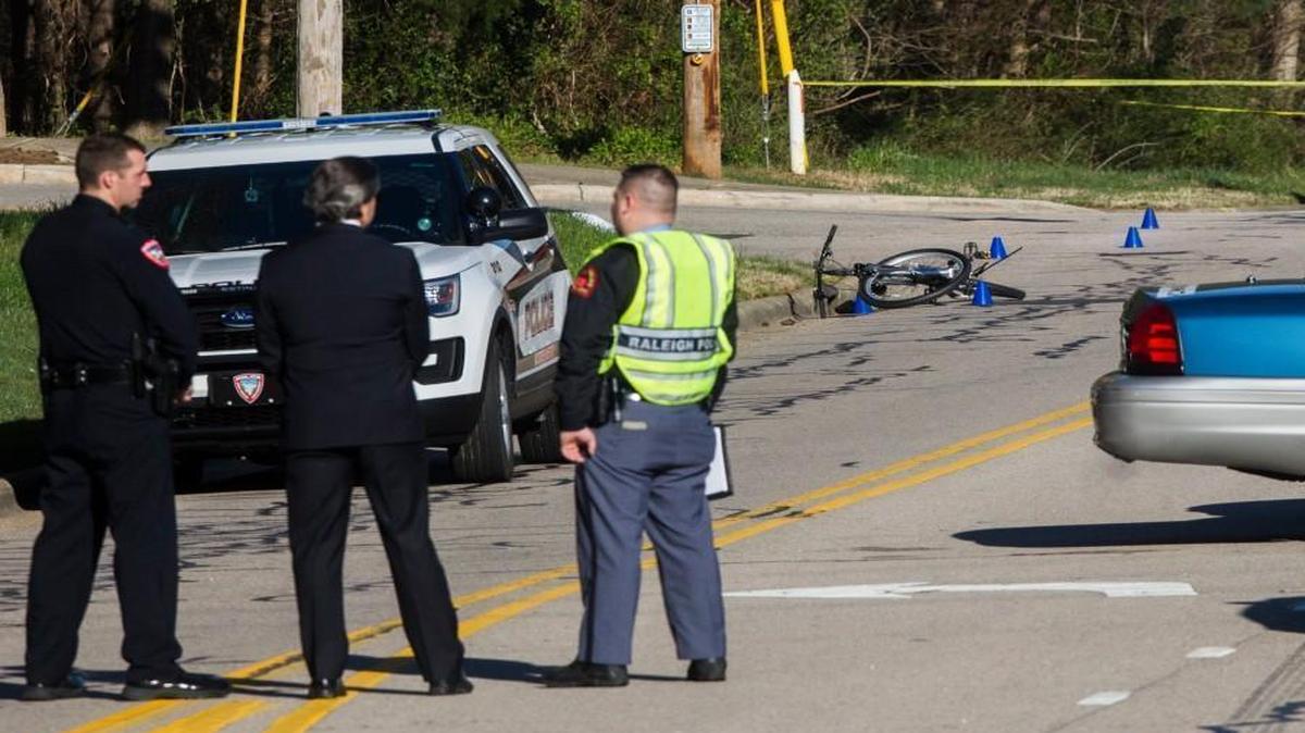 Emergency personnel work the scene of a fatal bicycle accident Monday morning, March 20, 2017 at the intersection of Trinity Road and Corprate Center Drive in Raleigh.