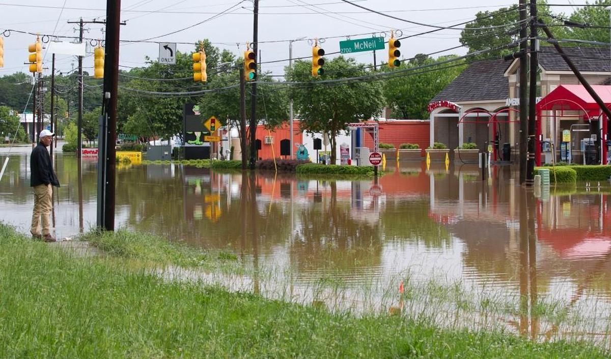David Wilson surveys the the flood damage to his properties on Paula Street from his vantage point on Wake Forest Road after record rain flooded the area adjacent to Crabtree Creek on Tuesday, April 25, 2017 in Raleigh, N.C.