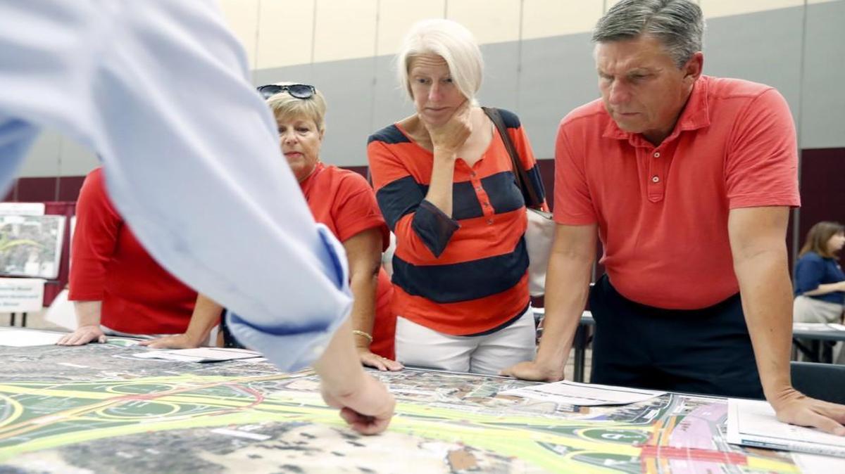 From left, Beth Weaver, Jennifer Cates and John Cates look over a map of possible changes with Joseph Hummer with the N.C. Department of Transportation during an NCDOT open house for the public to look at project design maps for the proposed improvements to I-440 at McKimmon Conference and Training Center in Raleigh on Tuesday, Aug. 8, 2017.