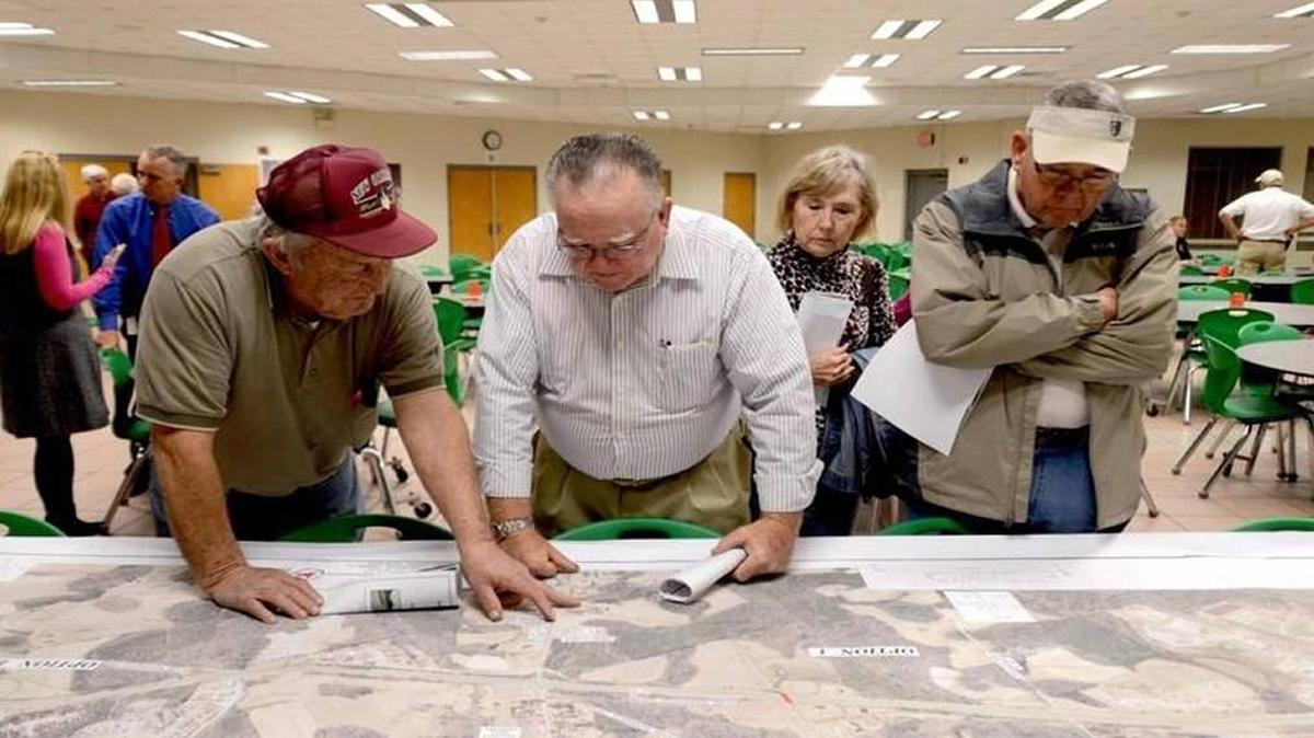Wilson’s Mills residents stare at a map of coming changes to U.S. 70 during a public meeting in February of last year.