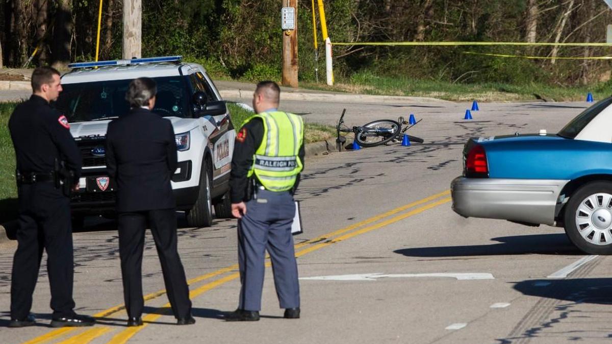Emergency personnel work the scene of a fatal bicycle accident Monday morning, March 20, 2017 at the intersection of Trinity Road and Corporate Center Drive in Raleigh.