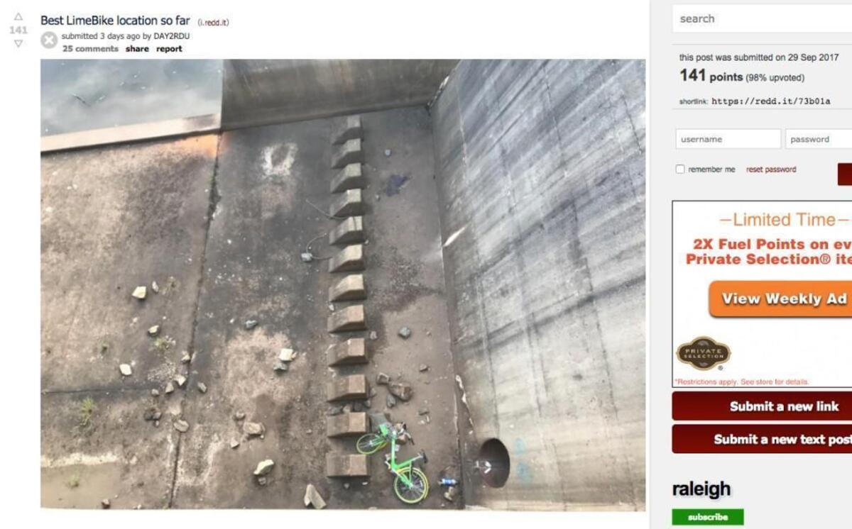 A screenshot of a photo in the Raleigh Reddit showing a LimeBike at the bottom of the Lake Raleigh dam.