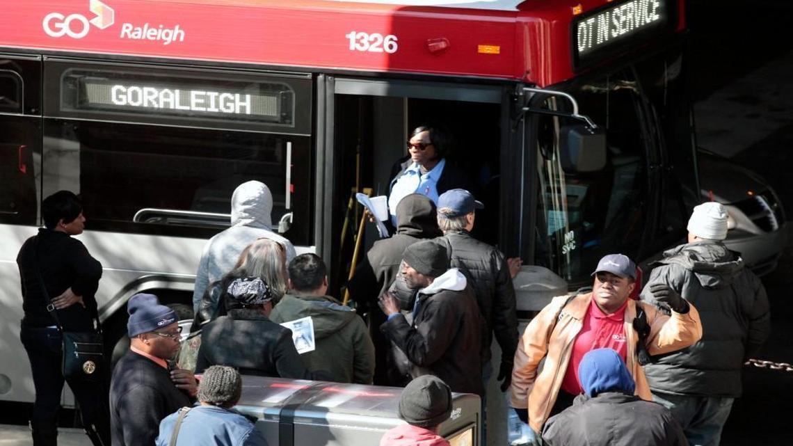 Bus riders line up outside a GoRaleigh bus at the Moore Square station in downtown Raleigh in February 2016. GoRaleigh and other Triangle transit agencies have seen an increase in “non-destination” riders since they stopped collecting fares during the COVID-19 pandemic.