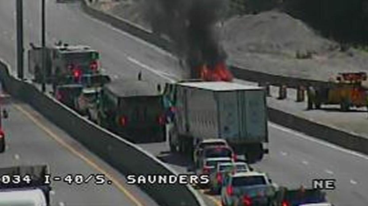 Flames and smoke come from a car that caught on fire near the South Saunders Street interchange of Interstate 40 in downtown Raleigh on Tuesday, May 16, 2017.