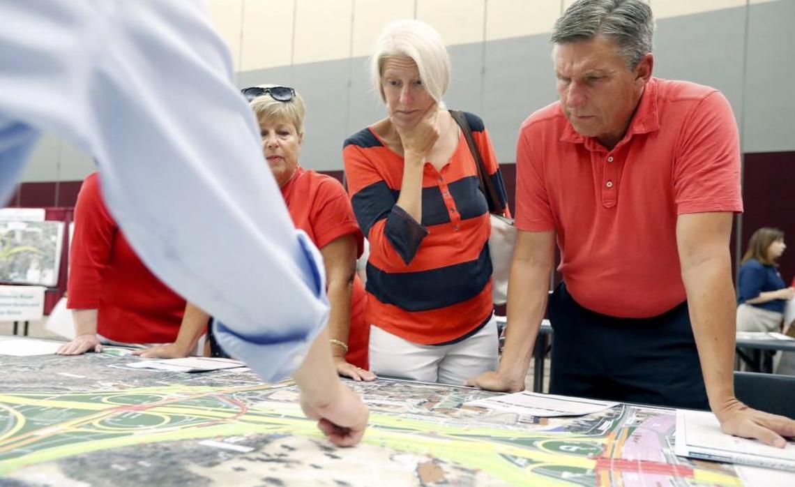 From left, Beth Weaver, Jennifer Cates and John Cates look over a map of N.C. Department of Transportation plans to widen the Beltline in West Raleigh during a NCDOT open house in August 2017. NCDOT has awarded a contract and construction will begin early next year.