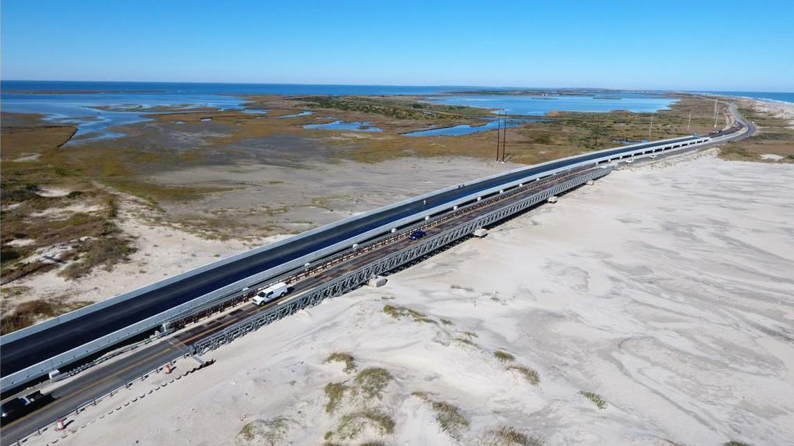 The new concrete Pea Island Interim Bridge, left, parallels the temporary metal truss bridge that was erected to carry N.C. 12 over a new inlet created by Hurricane Irene in 2011. Sand has since filled in the inlet, but the area is still vulnerable to breach in storms.