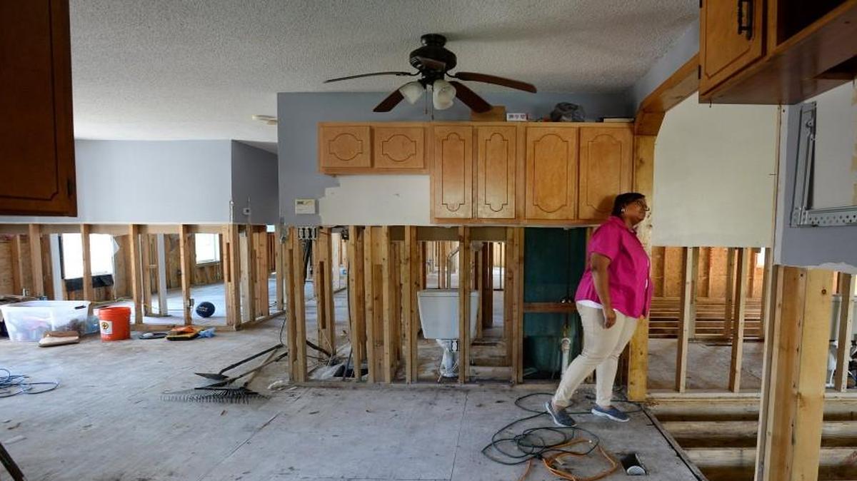 Latisha Beatty looks from the kitchen into the family room during a bi-weekly check on her property in Ivanhoe, earlier this year. Her Pender County home was swamped by the Black River following Hurricane Matthew in October. Pender County is one of many where volunteers are trying to repair and rebuild homes.