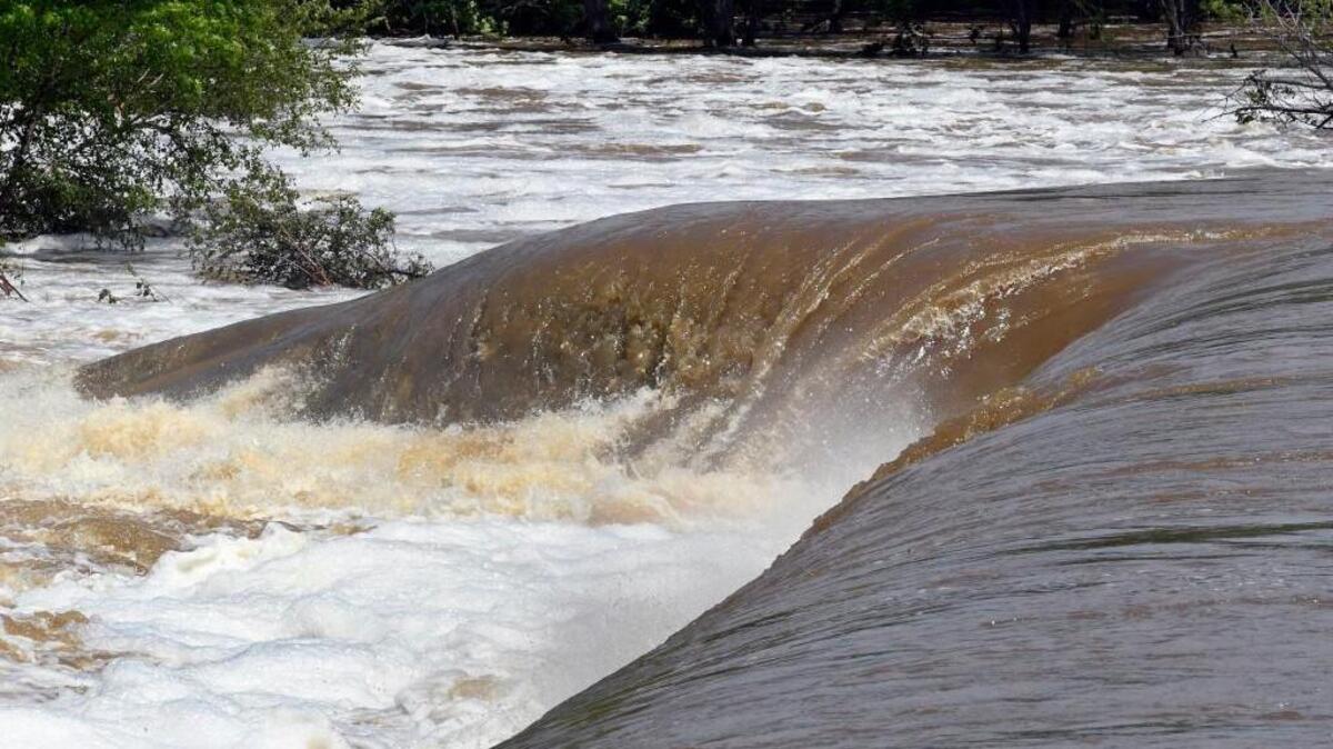 The Tar River roils as it cascades over the spillway at the Rocky Mount Mill Pond on the Tar River in Rocky Mount, N.C., Thursday, April 27, 2017. Floodwaters have started to subside in the town after the heavy rains earlier this week but a steady stream of onlookers were coming to the city park to watch the floodwaters tumble over the spillway.