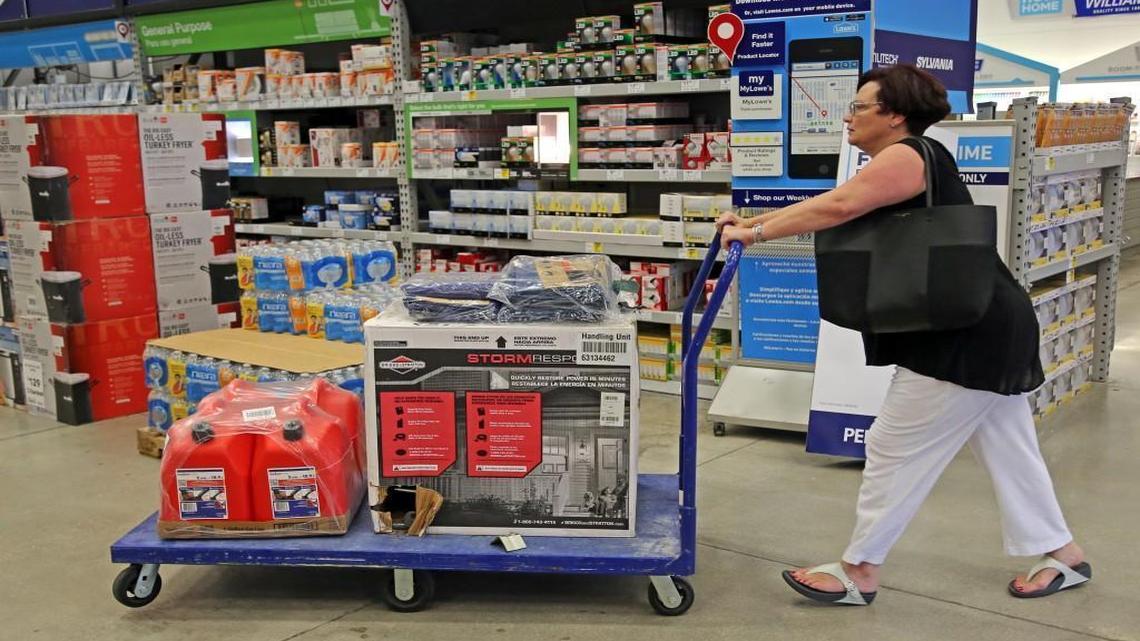 Kerri Vittimberga, of Wilton Manors, buys a generator, tarps and gas cans at Lowe's in Oakland Park, Fla., Tuesday, Oct. 4, 2016. Vittimberga, originally from Boston, says this is her "first big storm" in the two years she has lived in Florida. Anxious Florida residents raided grocery store shelves and North Carolina called for the evacuation of three barrier islands as Hurricane Matthew, the most powerful Atlantic storm in a about decade, threatened to rake a large swath of the East Coast in the coming days.
