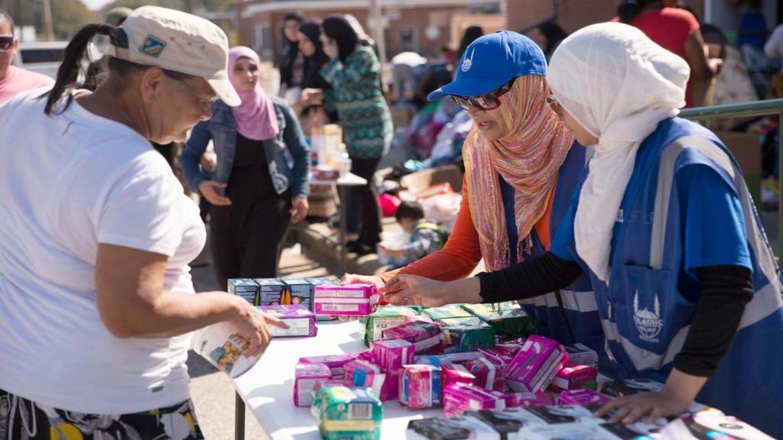 Nasima Chowdhury, center, and another volunteer from Islamic Relief USA hand out hygiene items to flood victims in Robeson County, North Carolina on Oct. 14, 2016.