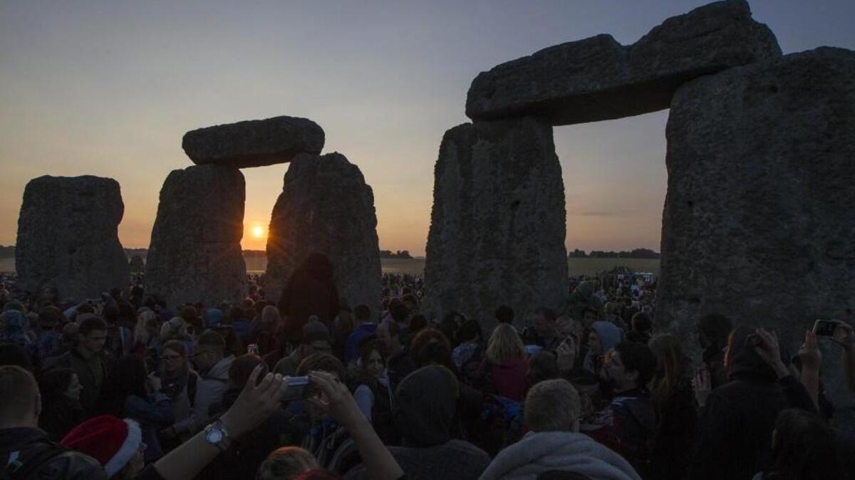 The sun rises as thousands of revelers gathered in 2014 at the ancient stone circle Stonehenge, near Salisbury, England, to celebrate the summer solstice, the longest day of the year. (AP Photo/Sang Tan)